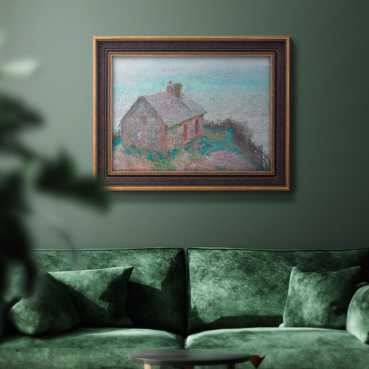 Impressionist coastal building landscape by Claude Monet in an ornate bronzed mahogany wood frame displayed in a dark-toned interior setting.