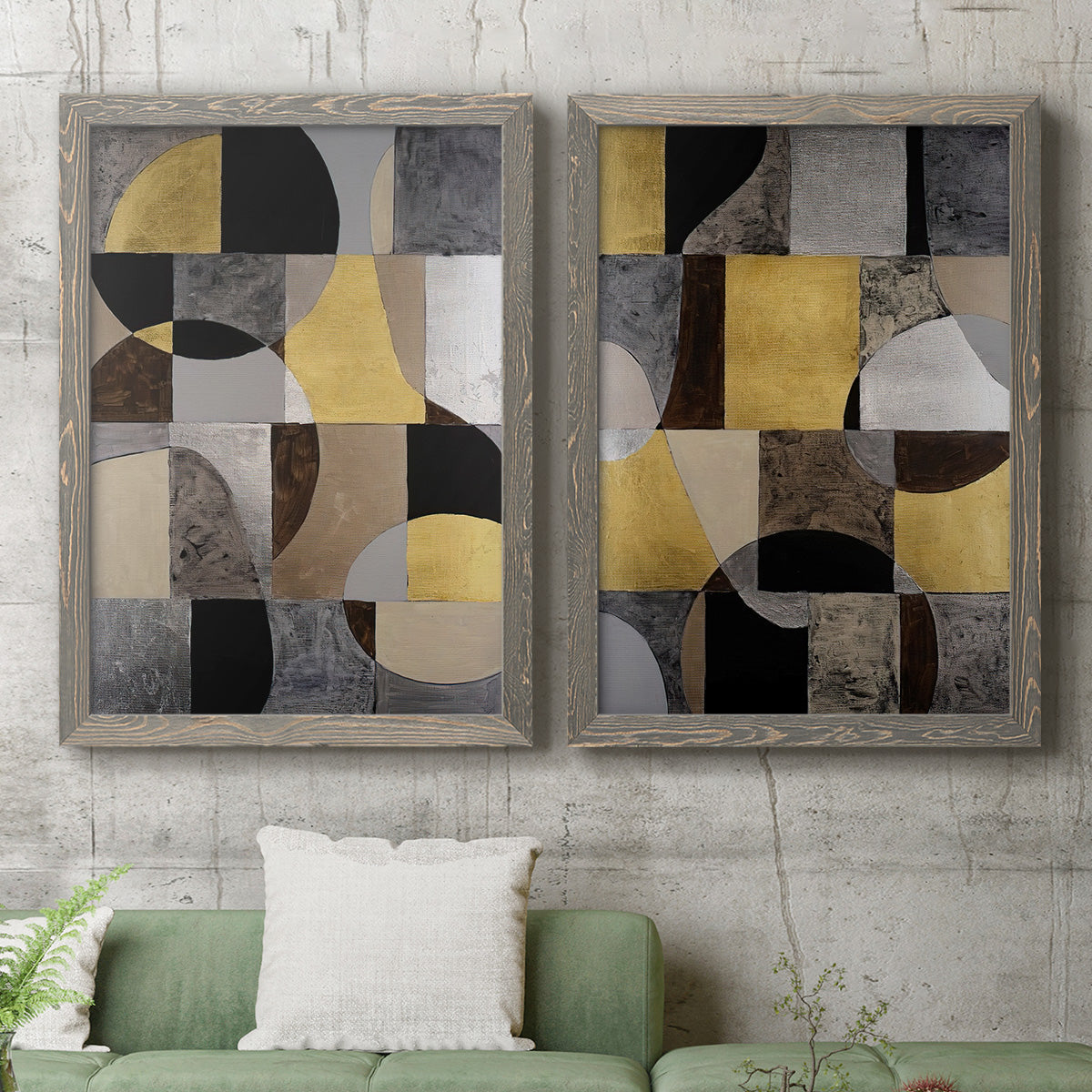 Set of two gray barnwood framed canvas prints depicting a coordinated art pair of interlocking black gray cream and gold geometric sections rendered as structured modern abstracts above a sofa in a modern living room.