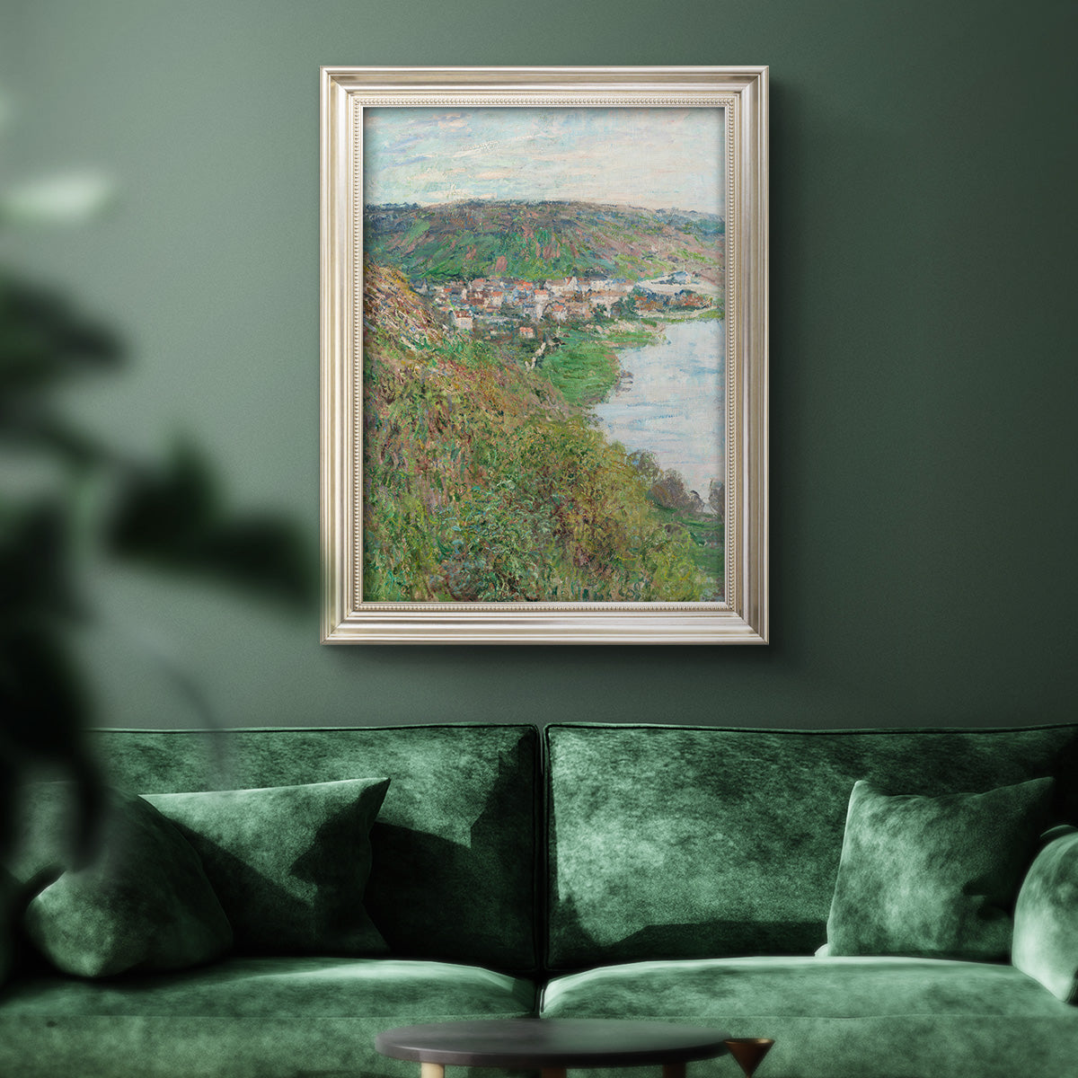 Impressionist landscape view of Vétheuil by Claude Monet in an ornate champagne frame displayed in a dark-toned interior setting.