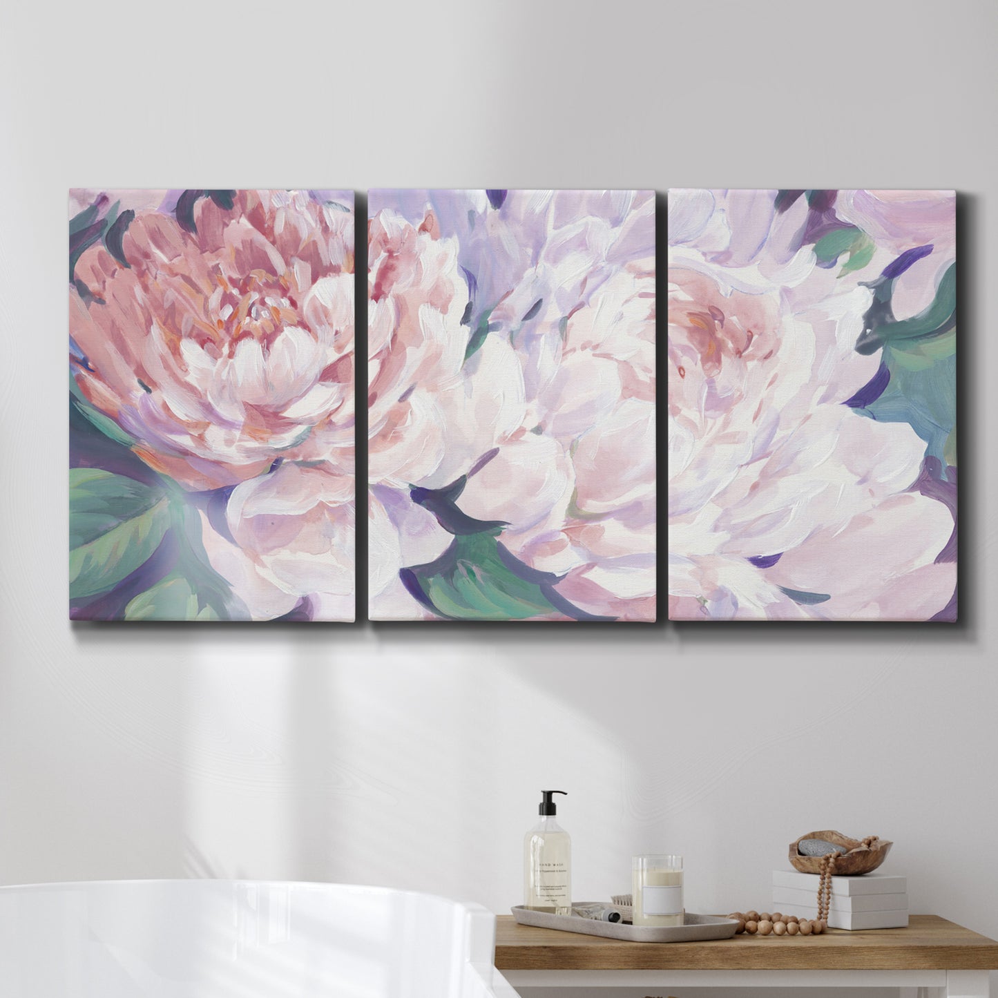 Three-panel canvas wall art featuring soft pink peonies in bloom, displayed in a bathroom above a bathtub.