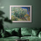 Impressionist lilac flower painting by Vincent van Gogh in an ornate weathered white frame displayed in a dark-toned interior setting.
