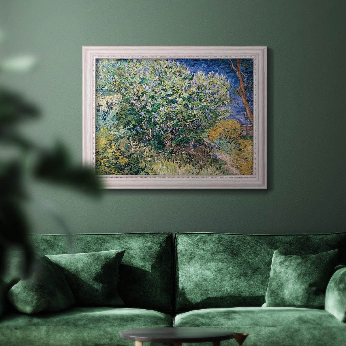 Impressionist lilac flower painting by Vincent van Gogh in an ornate weathered white frame displayed in a dark-toned interior setting.