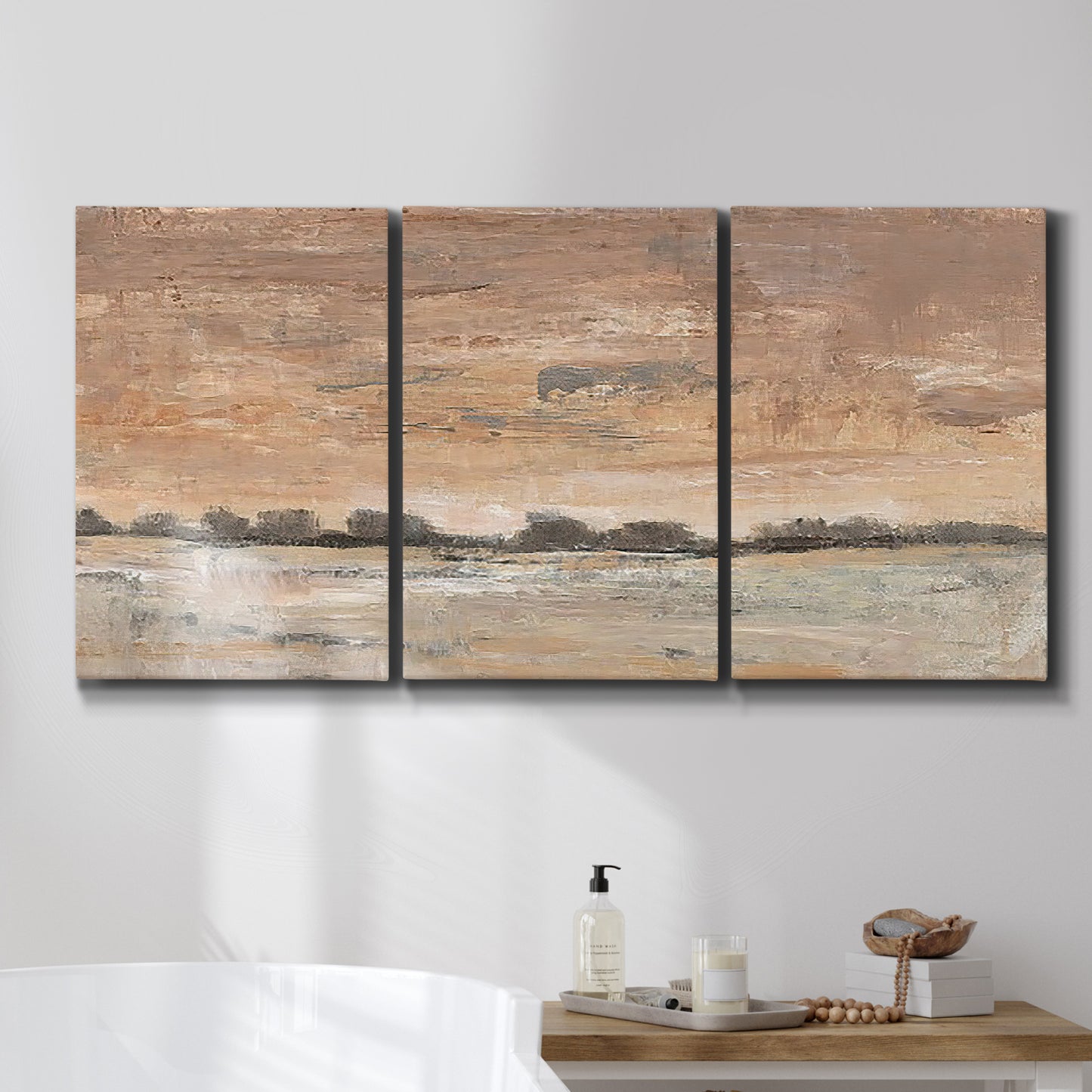 Three-panel canvas wall art featuring soft early evening landscape light, displayed in a bathroom above a bathtub.