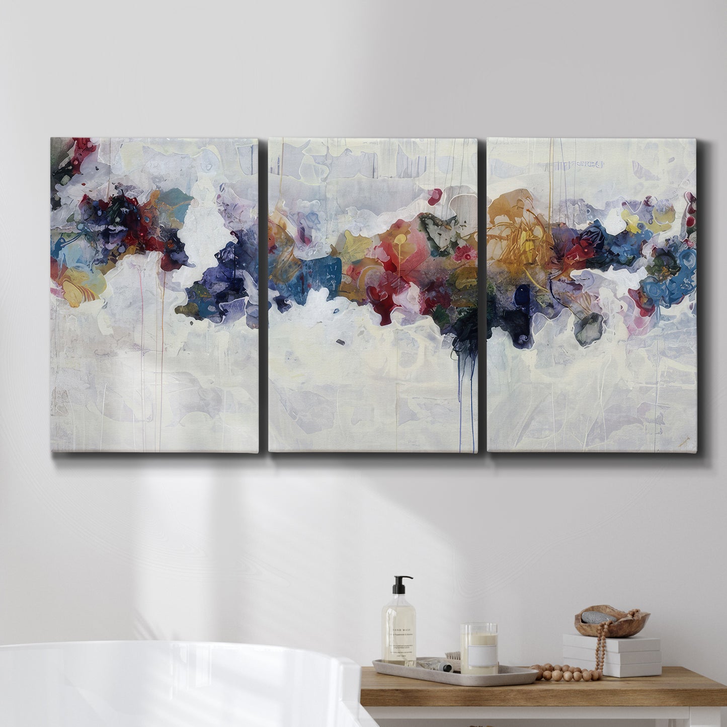 Three-panel canvas wall art featuring abstract water inspired composition, displayed in a bathroom above a bathtub.