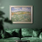 Impressionist countryside landscape near Auvers by Vincent van Gogh in an ornate champagne frame displayed in a dark-toned interior setting.