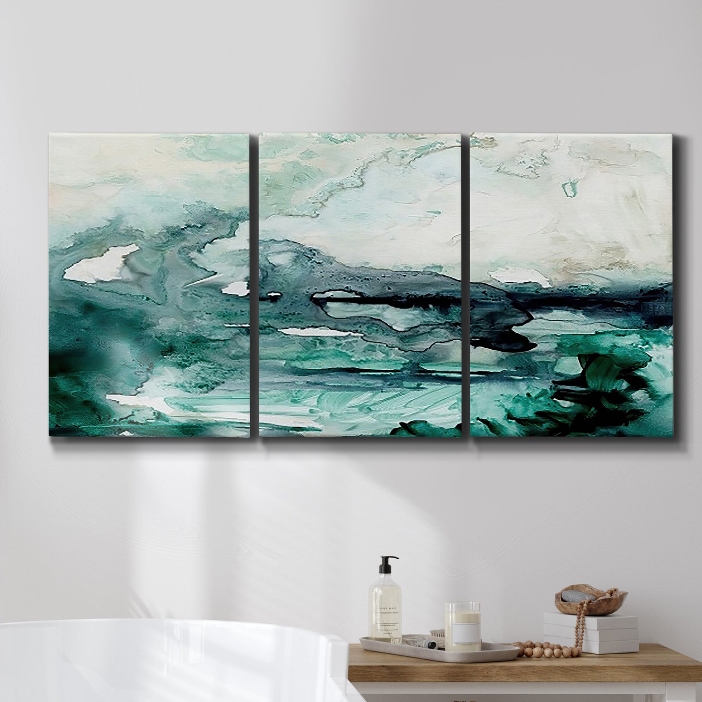 Three-panel canvas wall art featuring coastal abstract sea foam movement, displayed in a bathroom above a bathtub.