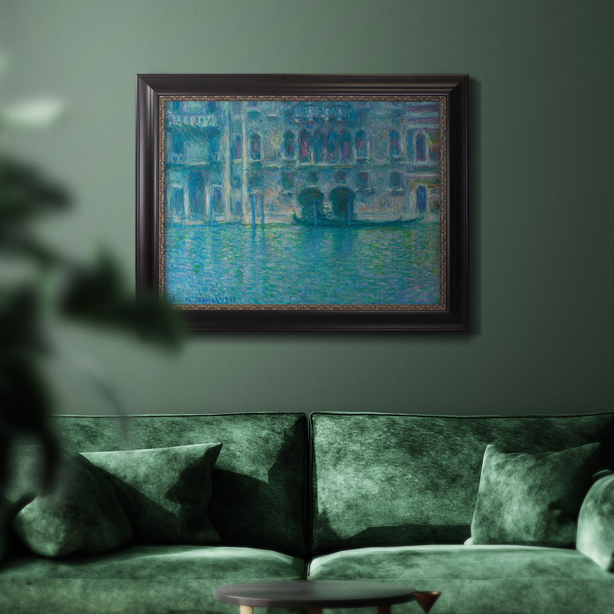 Impressionist Venetian palace waterfront scene by Claude Monet in an ornate black frame with gilded inner detail displayed in a dark-toned interior setting.