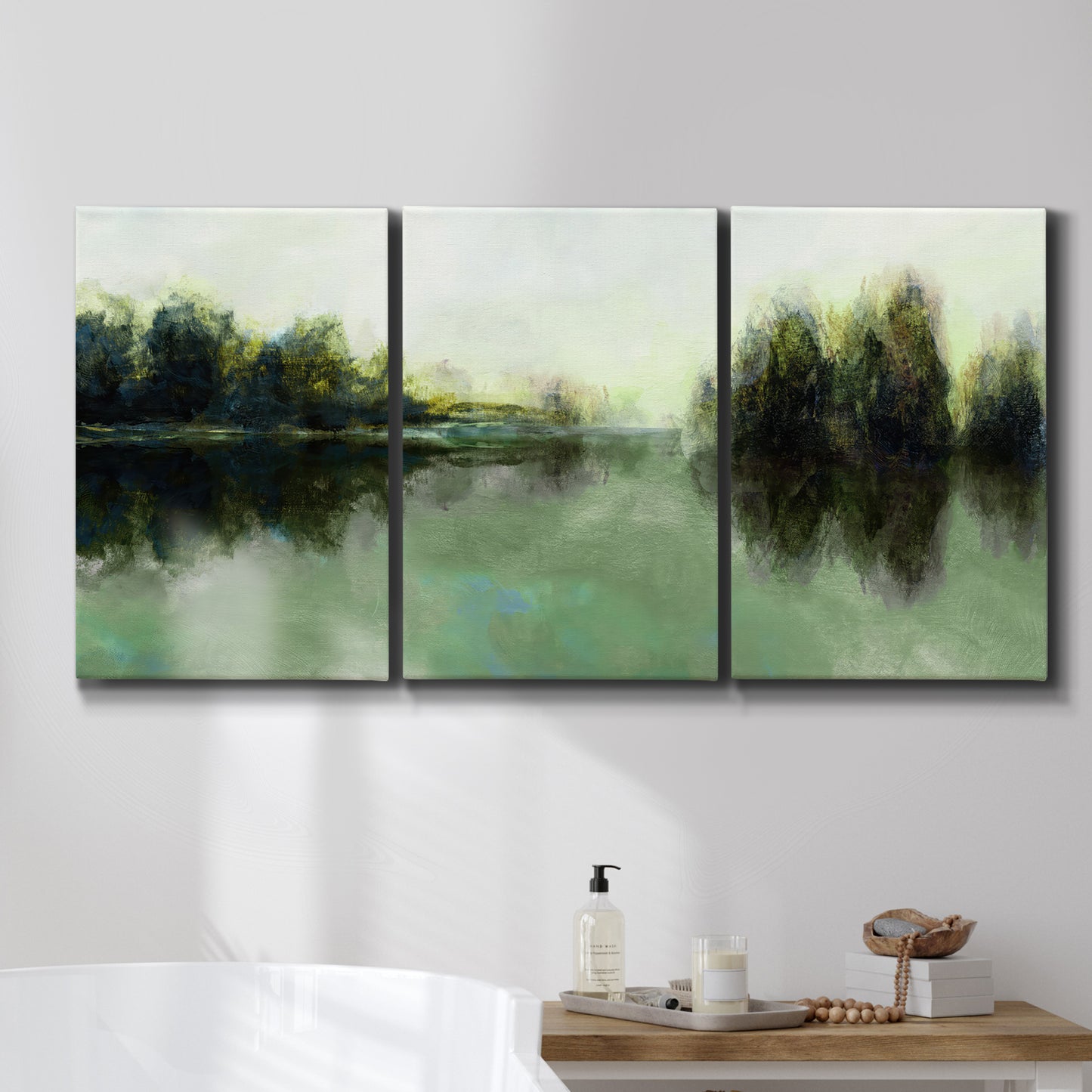 Three-panel canvas wall art featuring rain soaked landscape at sunset, displayed in a bathroom above a bathtub.