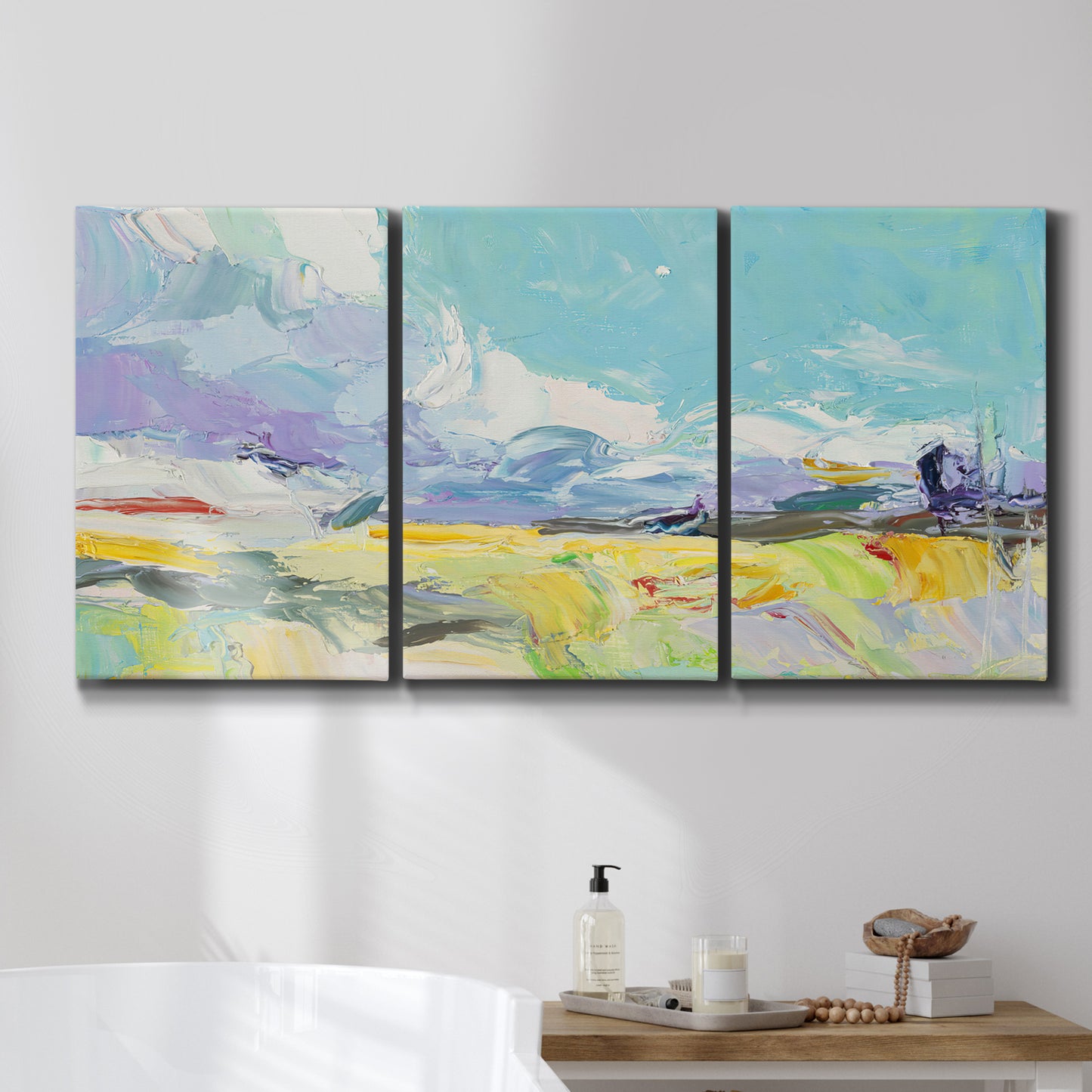 Three-panel canvas wall art featuring open landscape suggesting distant journey, displayed in a bathroom above a bathtub.