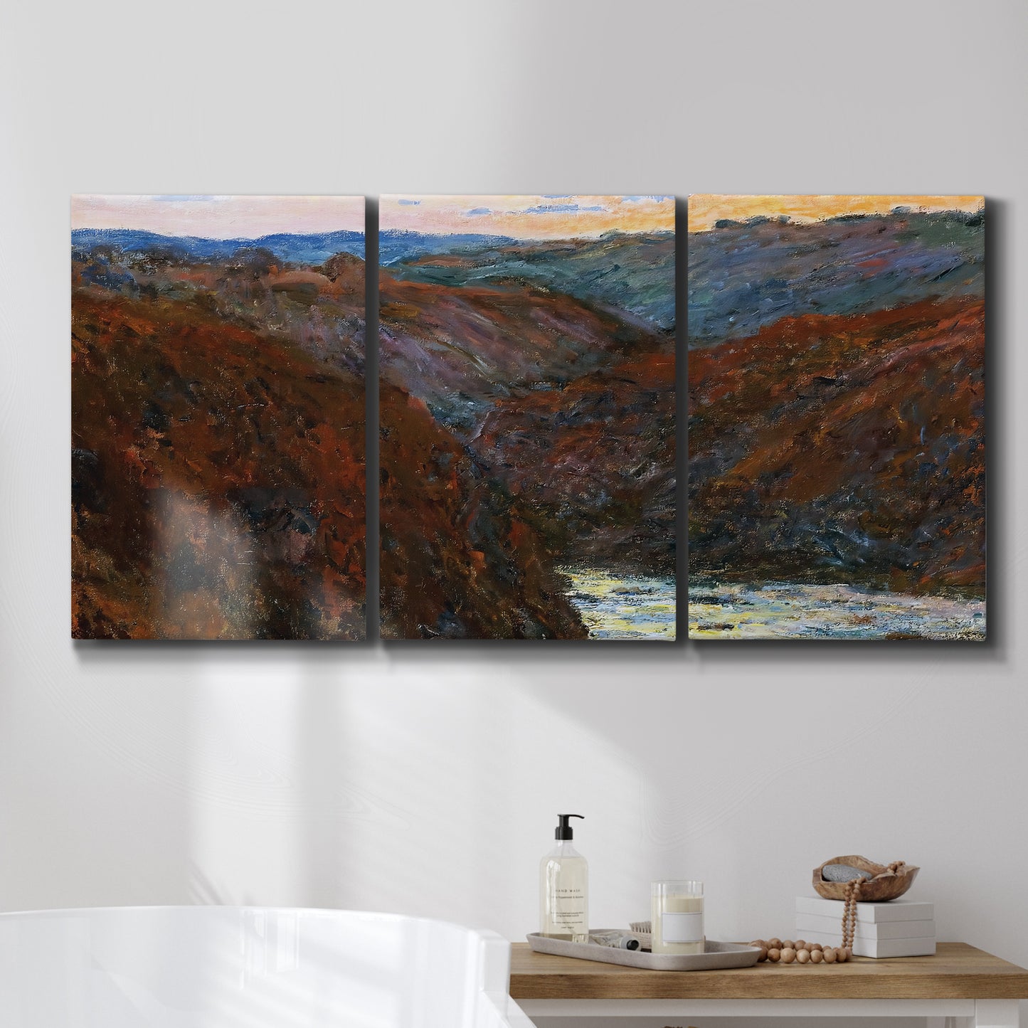Three-panel canvas wall art featuring impressionist valley landscape, displayed in a bathroom above a bathtub.