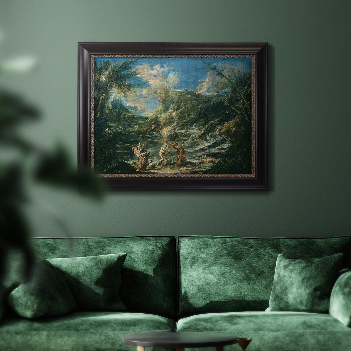Religious landscape depicting the baptism of Christ by Alessandro Magnasco in an ornate black frame with gilded inner detail displayed in a dark-toned interior setting.