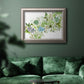 Minimalist abstract succulent botanical watercolor artwork in an ornate vintage silver frame displayed in a dark-toned interior setting.