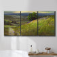 Three-panel canvas wall art featuring winding path through rolling hills, displayed in a bathroom above a bathtub.