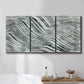 Three-panel canvas wall art featuring coastal shoreline with gentle surf, displayed in a bathroom above a bathtub.