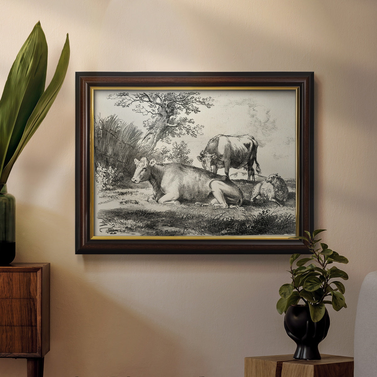 Classical pastoral landscape artwork by Nicolas Berchem in an ornate mahogany wood frame with gold liner displayed in a dark-toned interior setting.