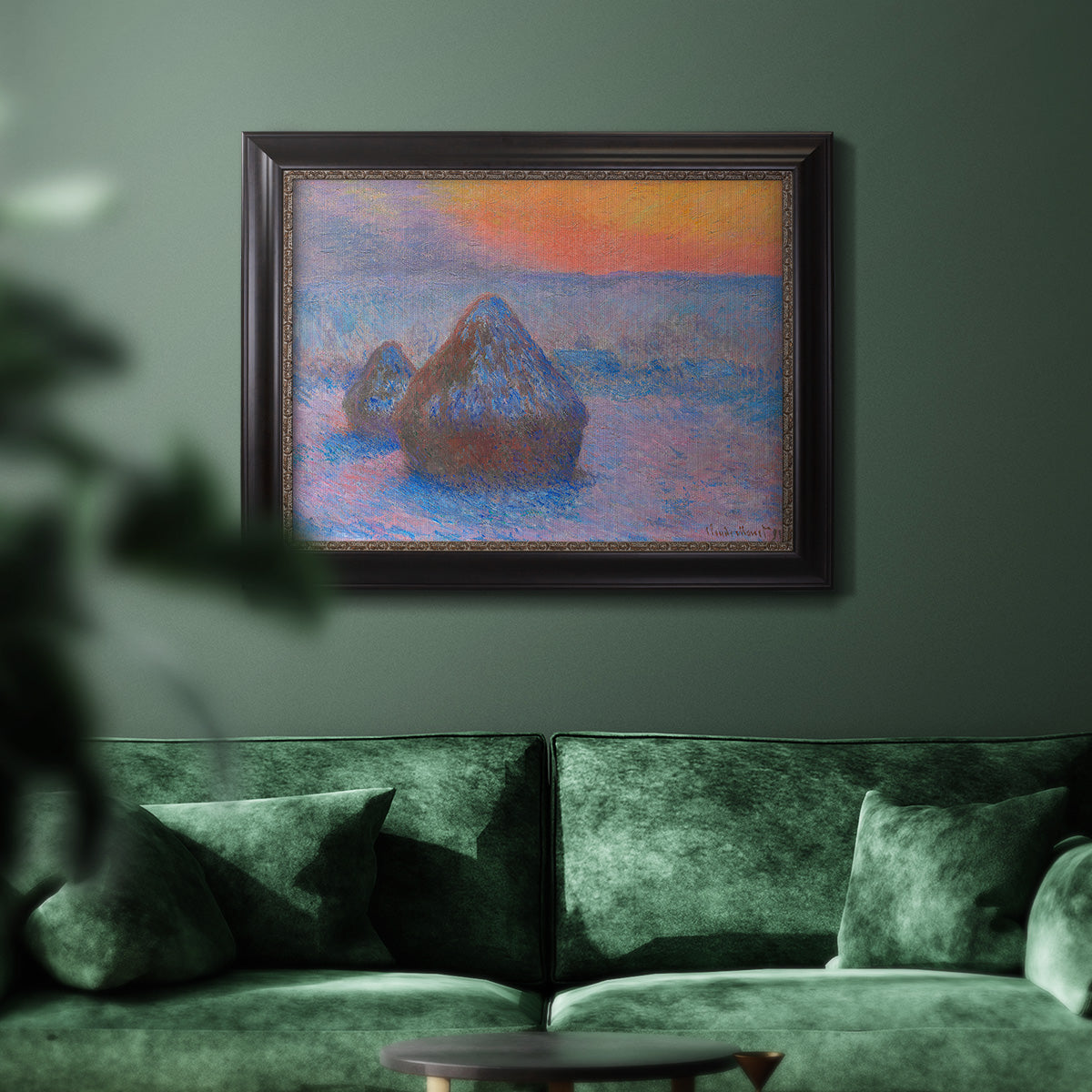 Impressionist haystack scene at sunset by Claude Monet in an ornate black frame with gilded inner detail displayed in a dark-toned interior setting.