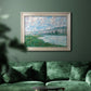 Impressionist river landscape at Vétheuil by Claude Monet in an ornate champagne frame displayed in a dark-toned interior setting.