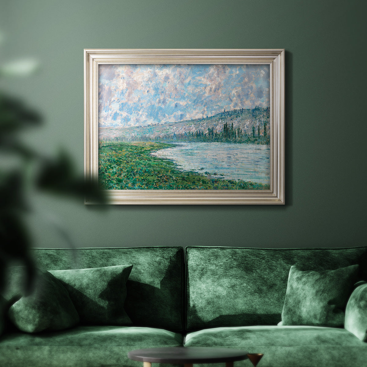 Impressionist river landscape at Vétheuil by Claude Monet in an ornate champagne frame displayed in a dark-toned interior setting.