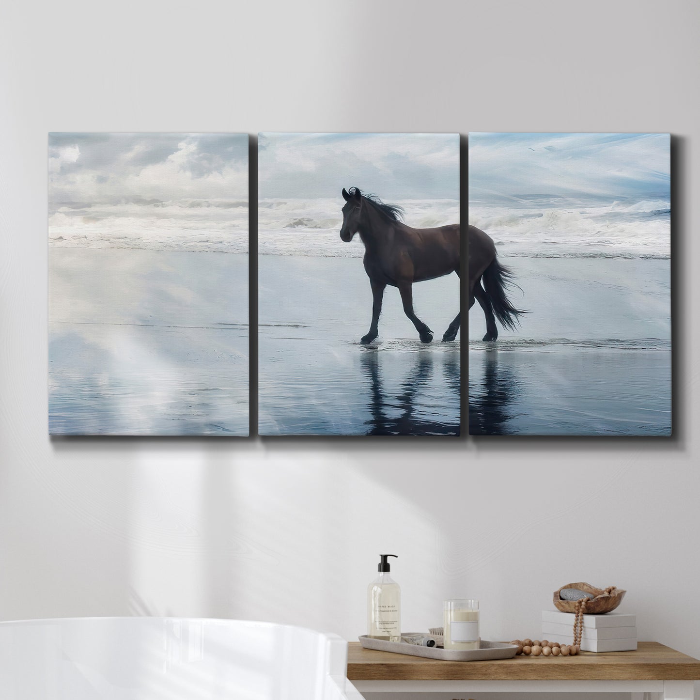 Three-panel canvas wall art featuring running horses captured mid stride, displayed in a bathroom above a bathtub.