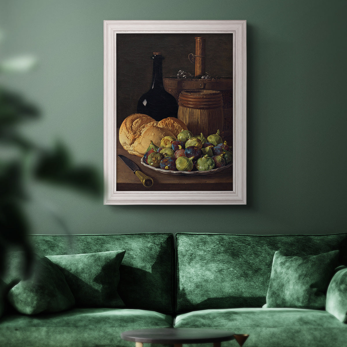 Realist still life with figs and bread by Luis Meléndez in an ornate weathered white frame displayed in a dark-toned interior setting.