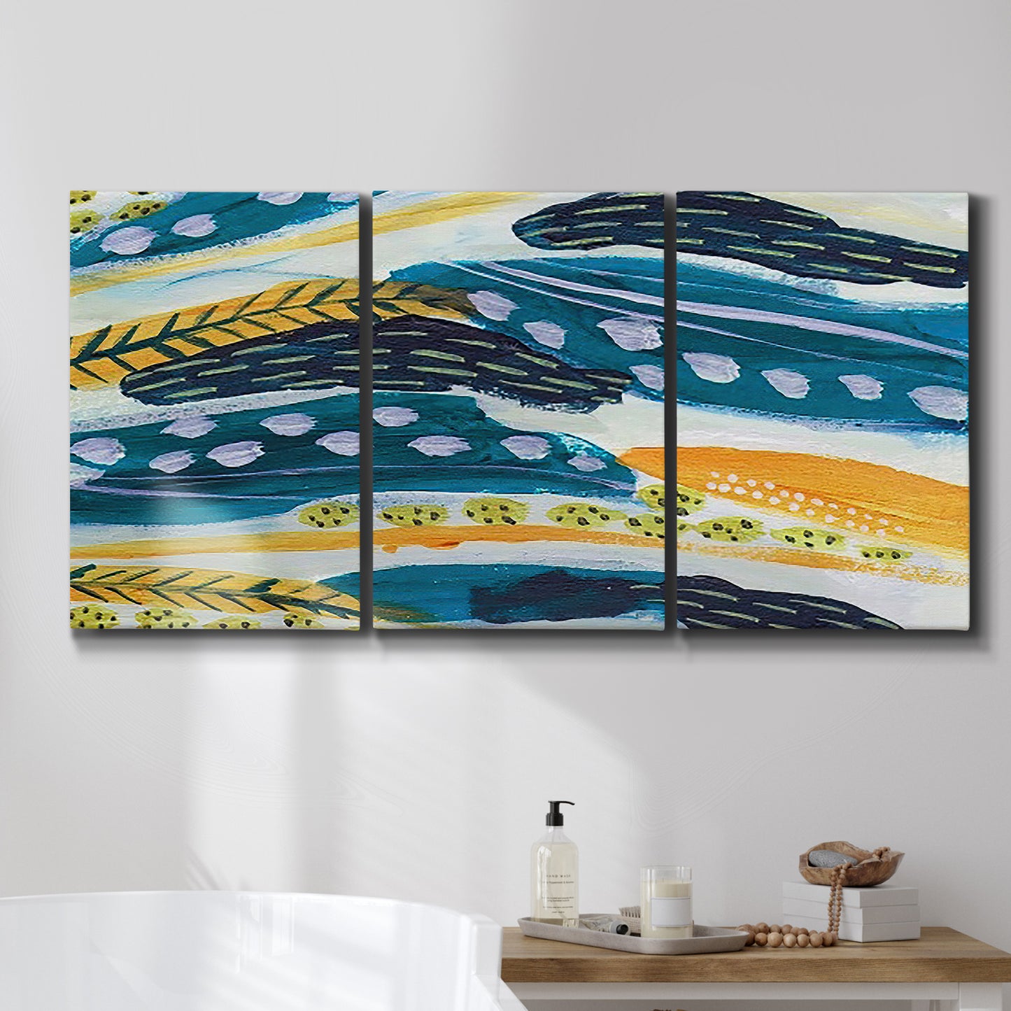 Three-panel canvas wall art featuring feather inspired abstract linear motion, displayed in a bathroom above a bathtub.