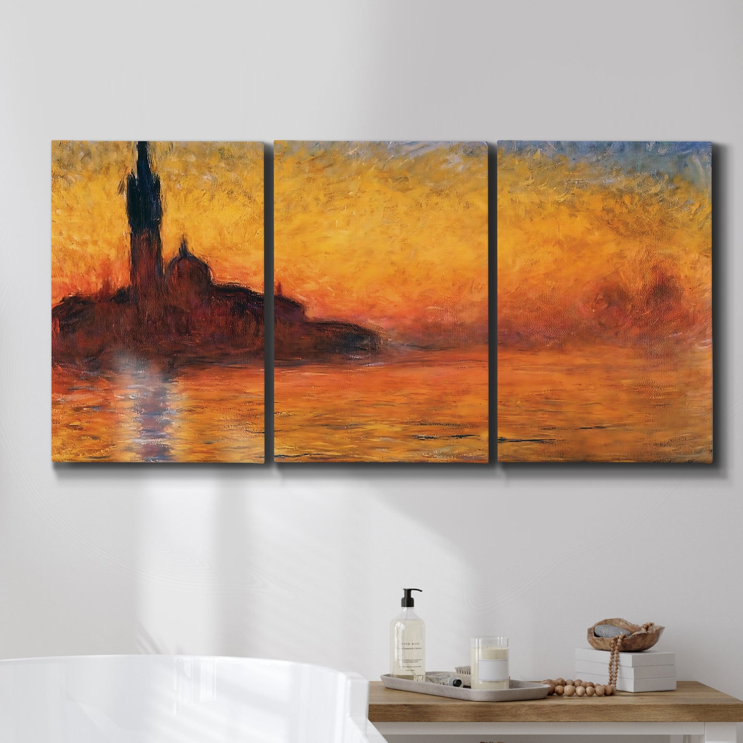 Three-panel canvas wall art featuring Venetian church at sunset, displayed in a bathroom above a bathtub.