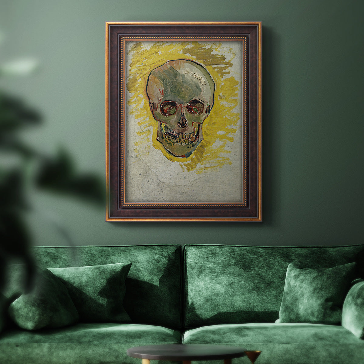 Expressive skull study painting by Vincent van Gogh in an ornate bronzed mahogany wood frame displayed in a dark-toned interior setting.