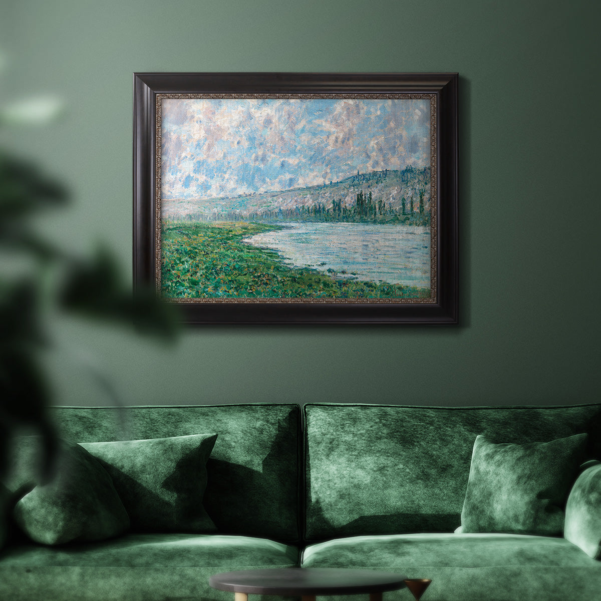 Impressionist river landscape at Vétheuil by Claude Monet in an ornate black frame with gilded inner detail displayed in a dark-toned interior setting.