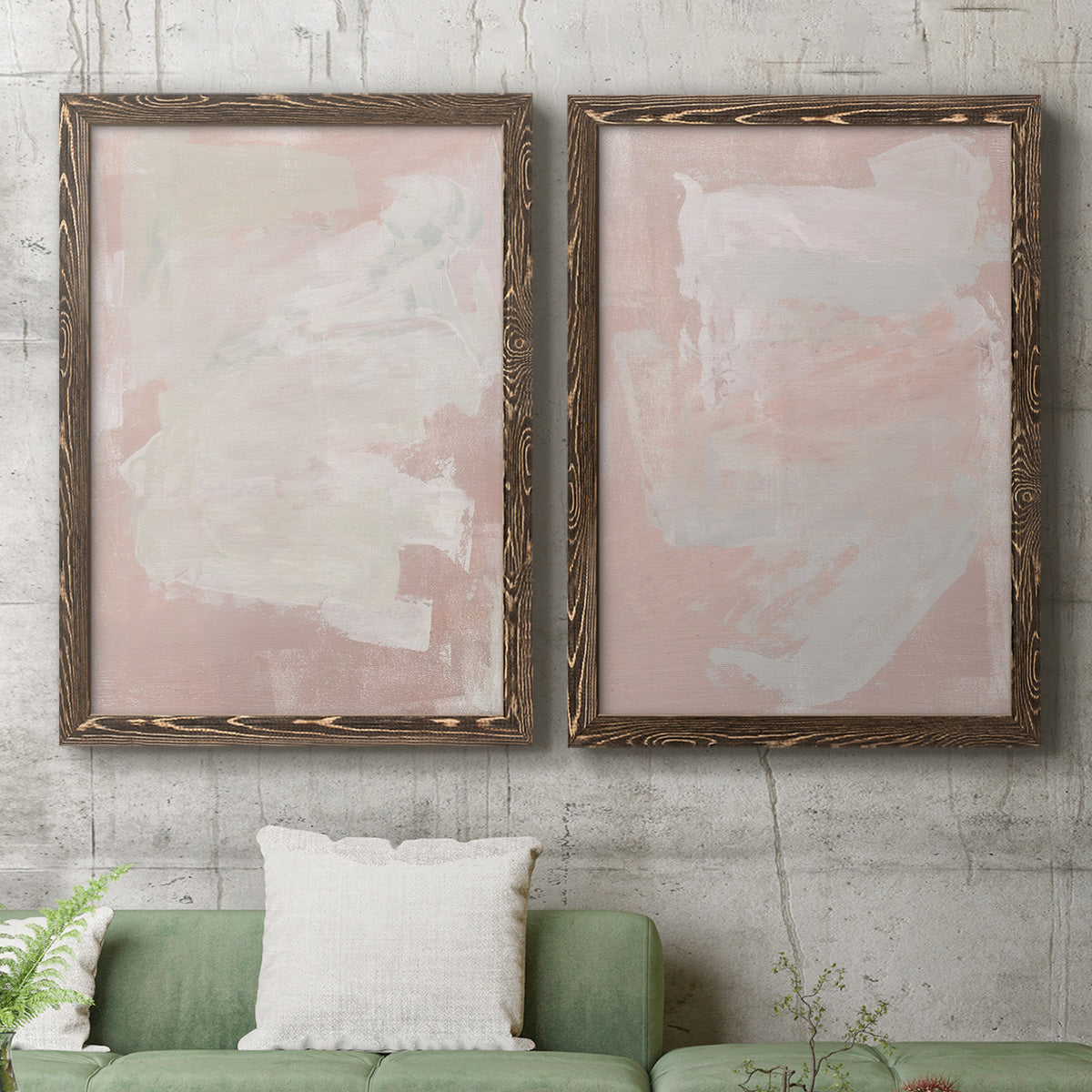 Set of two walnut barnwood framed canvas prints depicting a coordinated art pair of soft blush and white painterly fields rendered as minimalist color-field abstracts above a sofa in a modern living room.