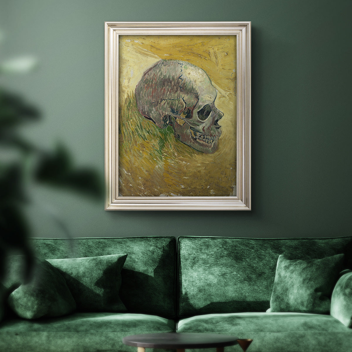 Profile skull study artwork by Vincent van Gogh in an ornate champagne frame displayed in a dark-toned interior setting.