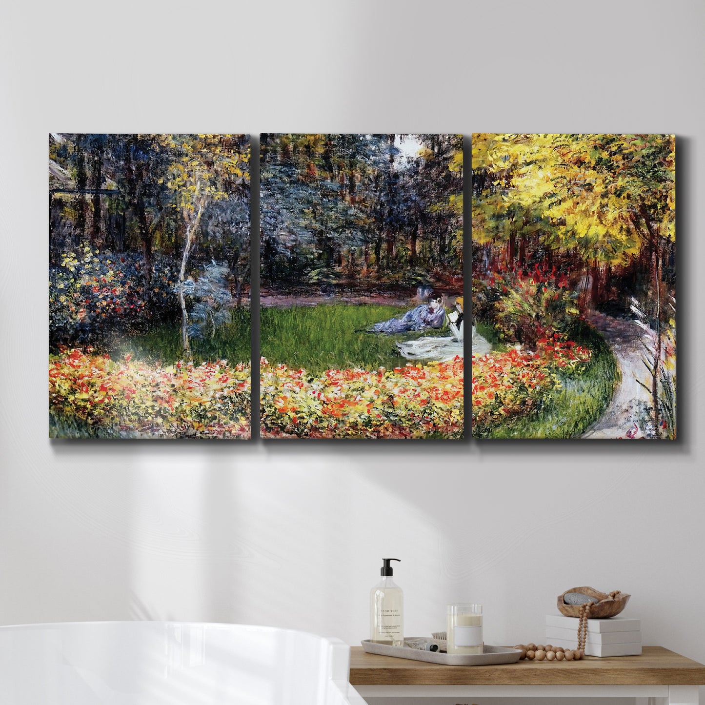 Three-panel canvas wall art featuring garden in full bloom by coast, displayed in a bathroom above a bathtub.