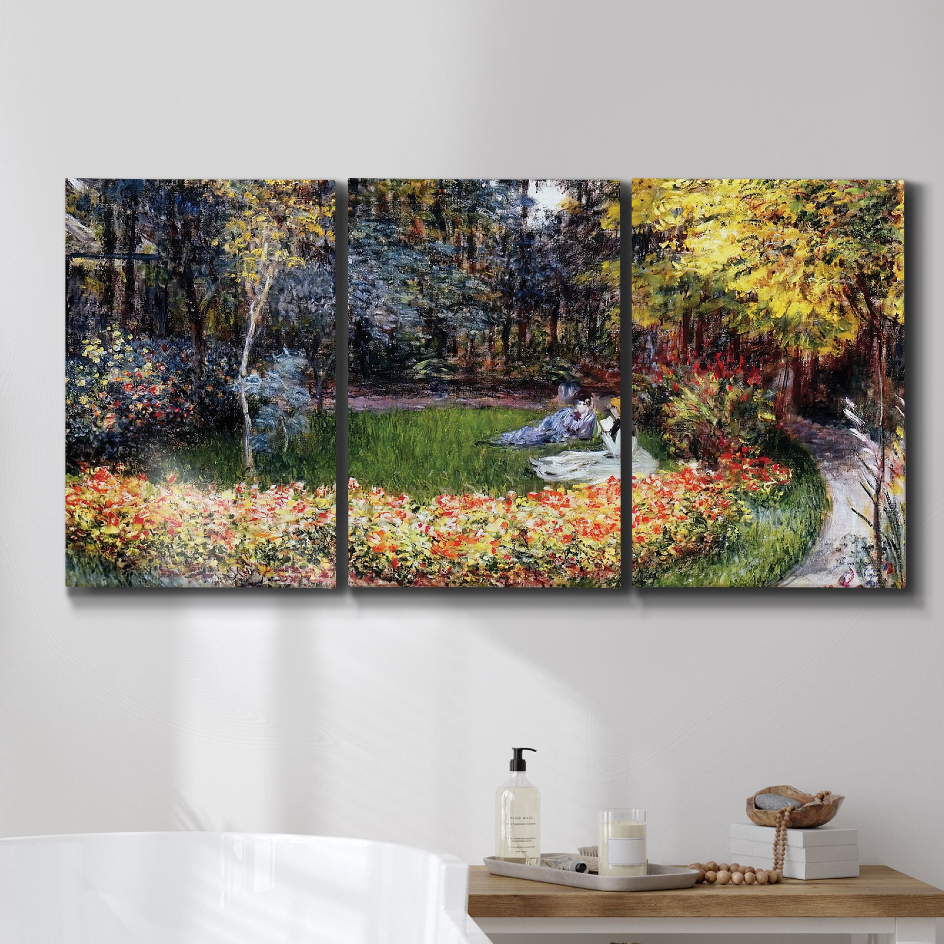 Three-panel canvas wall art featuring garden in full bloom by coast, displayed in a bathroom above a bathtub.