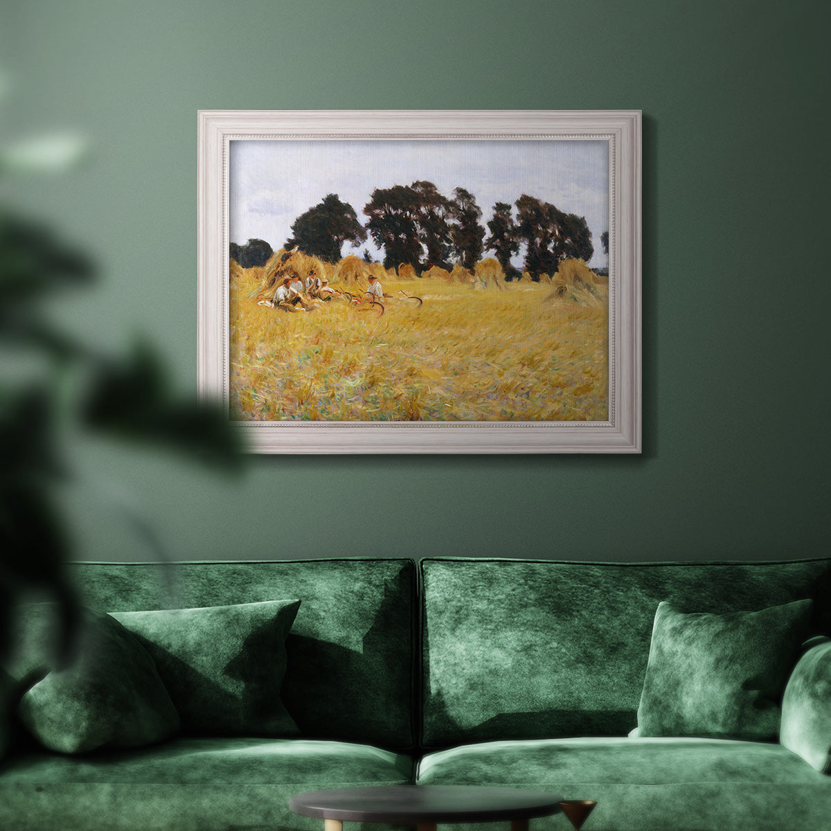 Impressionist rural harvest scene by John Singer Sargent in an ornate weathered white frame displayed in a dark-toned interior setting.