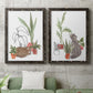 Set of two black barnwood framed canvas prints depicting a coordinated art pair of cats tucked among collections of potted houseplants rendered as whimsical botanical animal illustrations above a sofa in a modern living room.