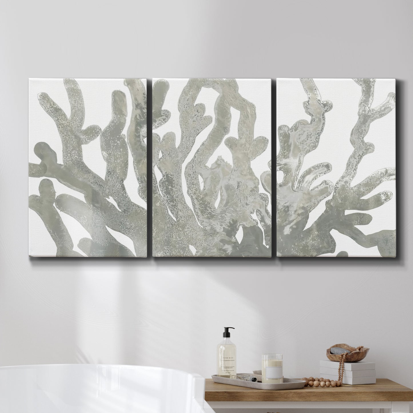 Three-panel canvas wall art featuring monochrome coral texture study, displayed in a bathroom above a bathtub.