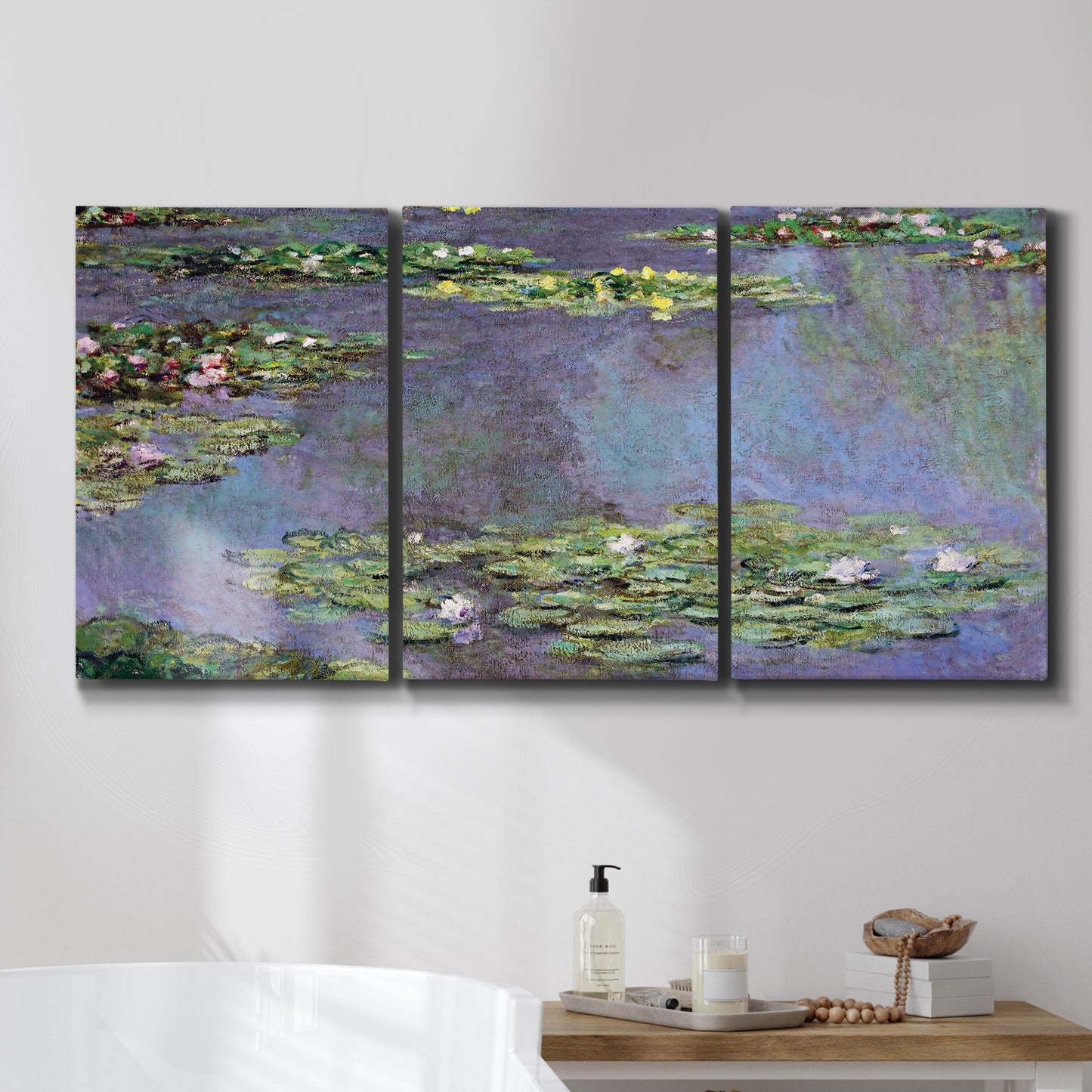 Three-panel canvas wall art featuring purple haze water lily pond, displayed in a bathroom above a bathtub.