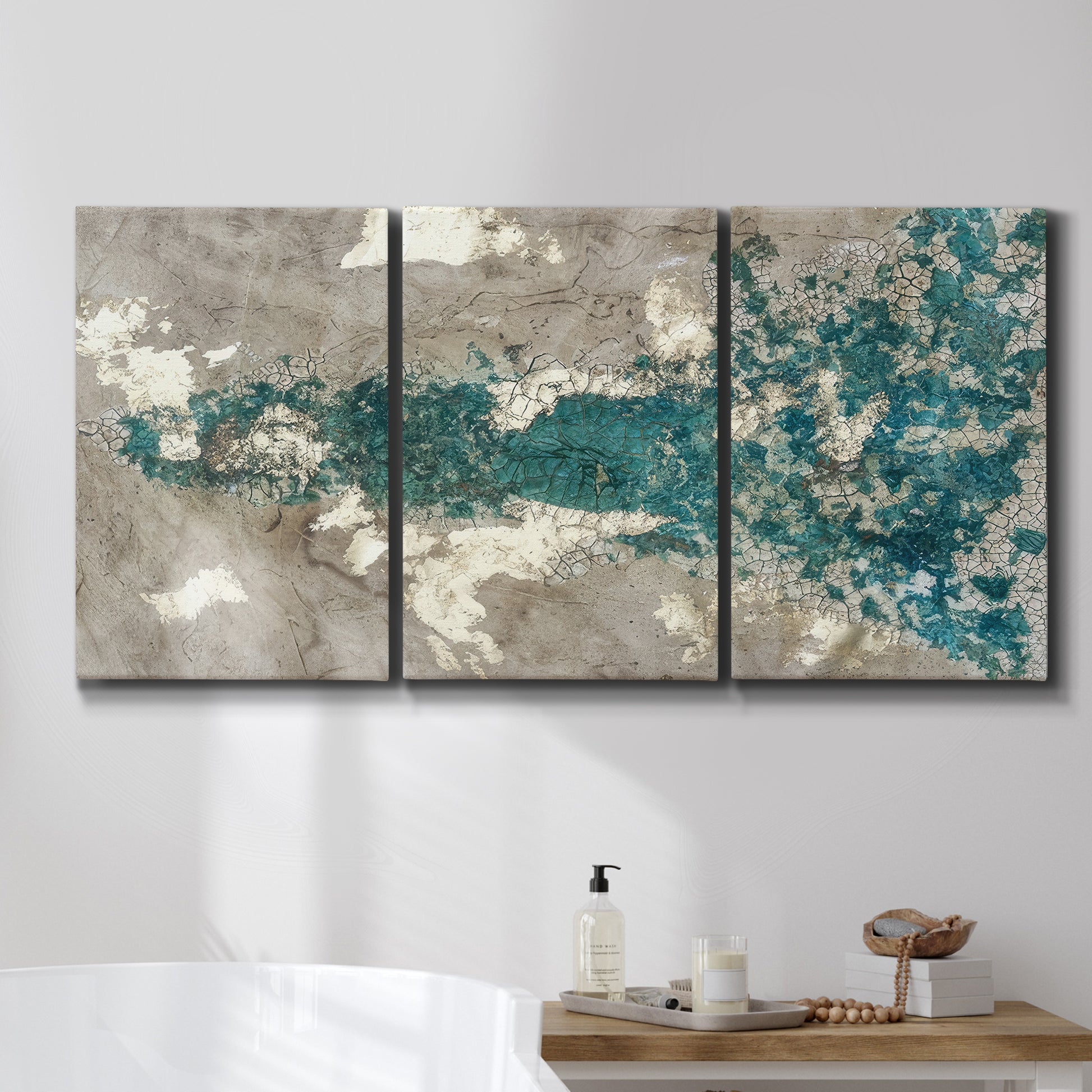 Three-panel canvas wall art featuring layered mineral abstract textures, displayed in a bathroom above a bathtub.