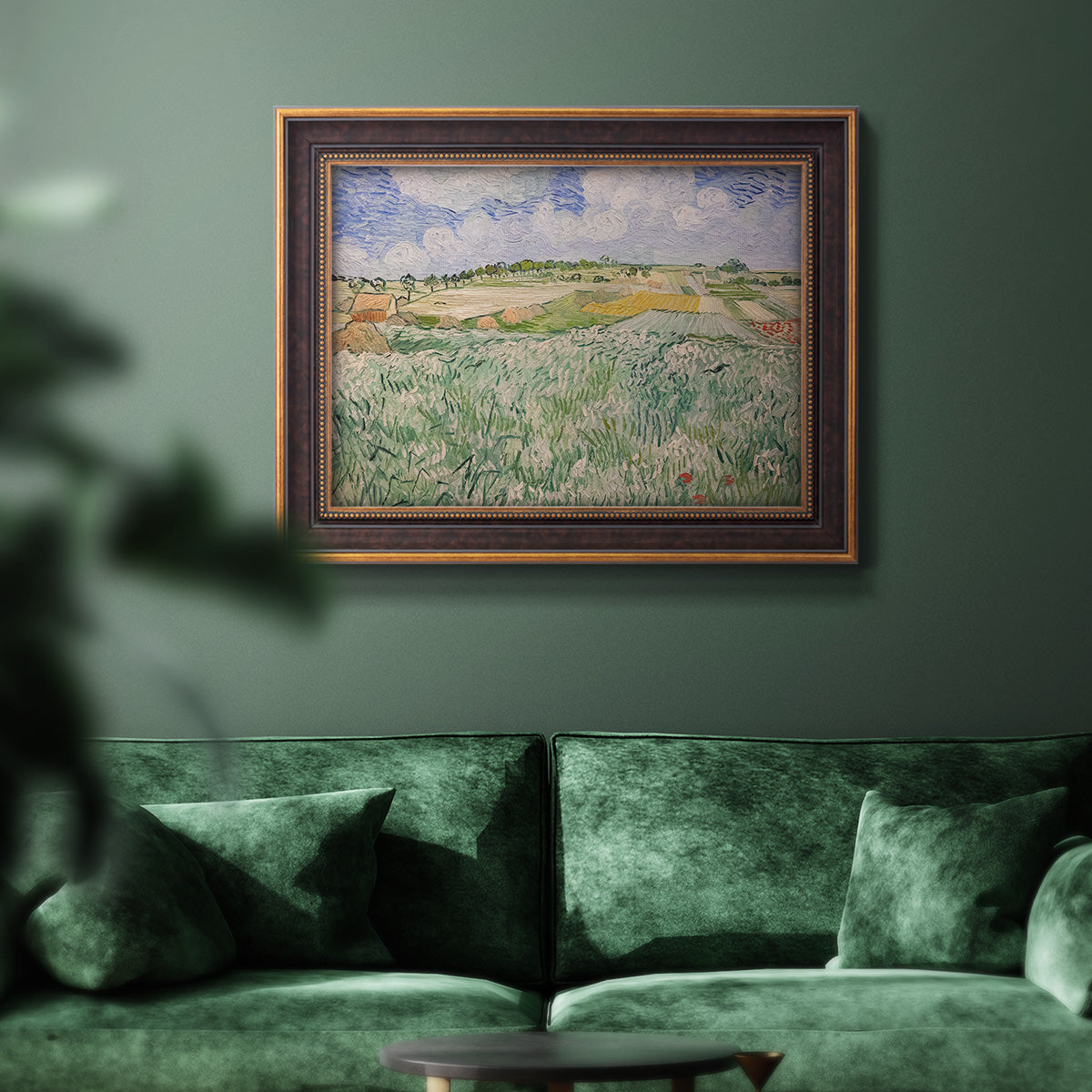 Impressionist countryside landscape near Auvers by Vincent van Gogh in an ornate bronzed mahogany wood frame displayed in a dark-toned interior setting.