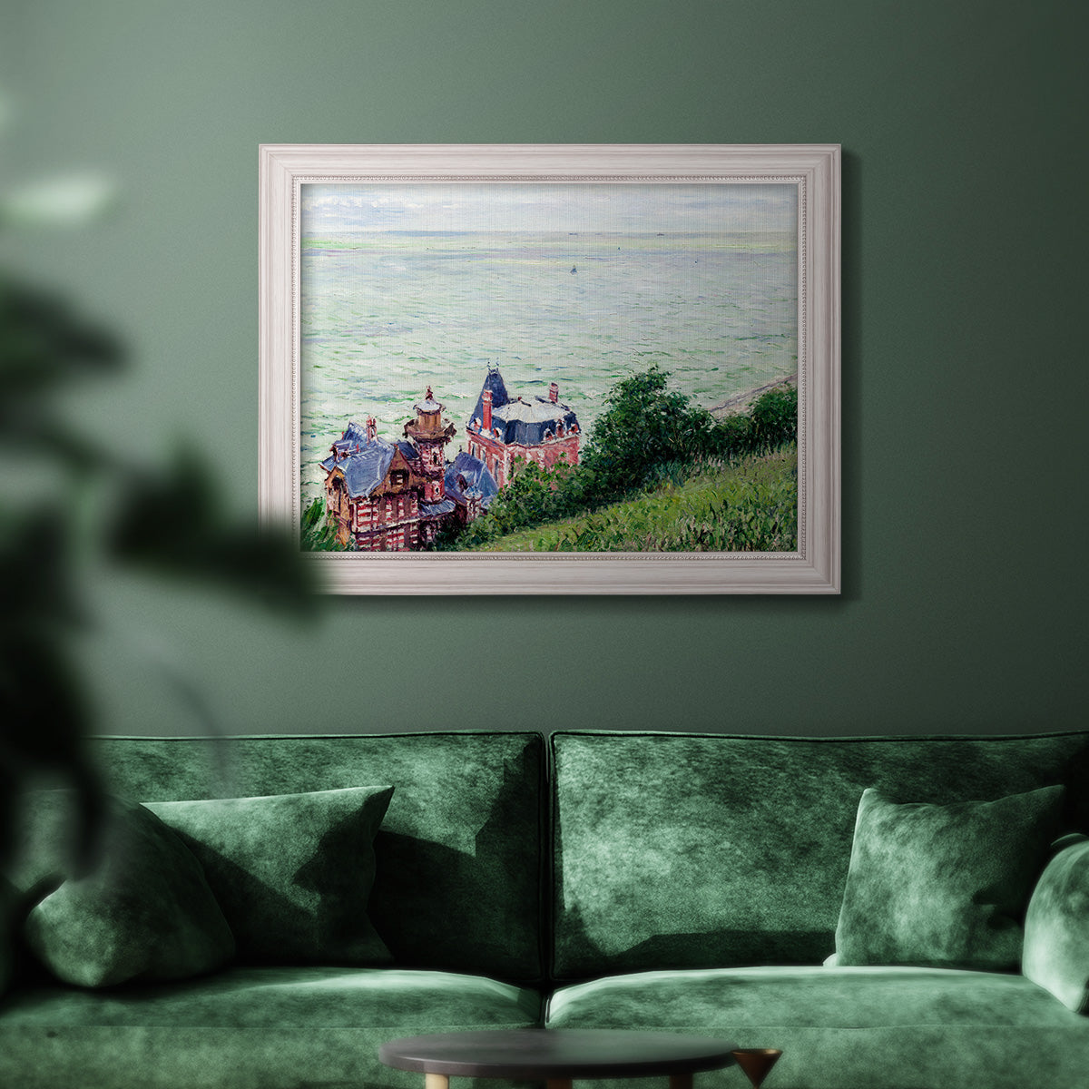 Impressionist coastal villas landscape by Gustave Caillebotte in an ornate weathered white frame displayed in a dark-toned interior setting.