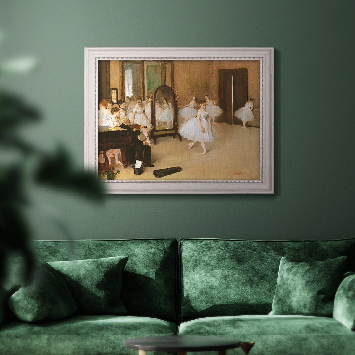 Impressionist dance class interior scene by Edgar Degas in an ornate weathered white frame displayed in a dark-toned interior setting.