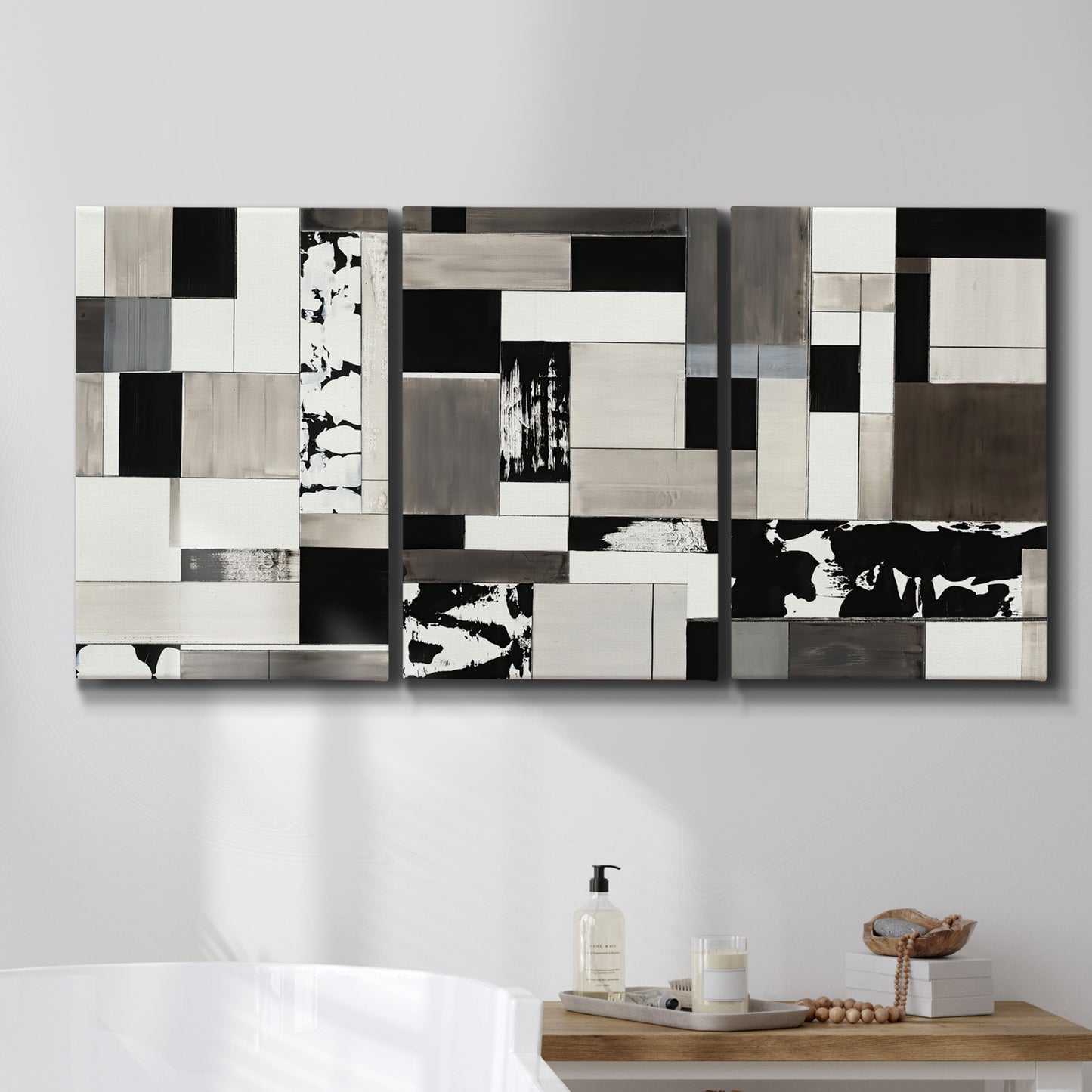 Three-panel canvas wall art featuring rectangular mid century geometric abstraction, displayed in a bathroom above a bathtub.