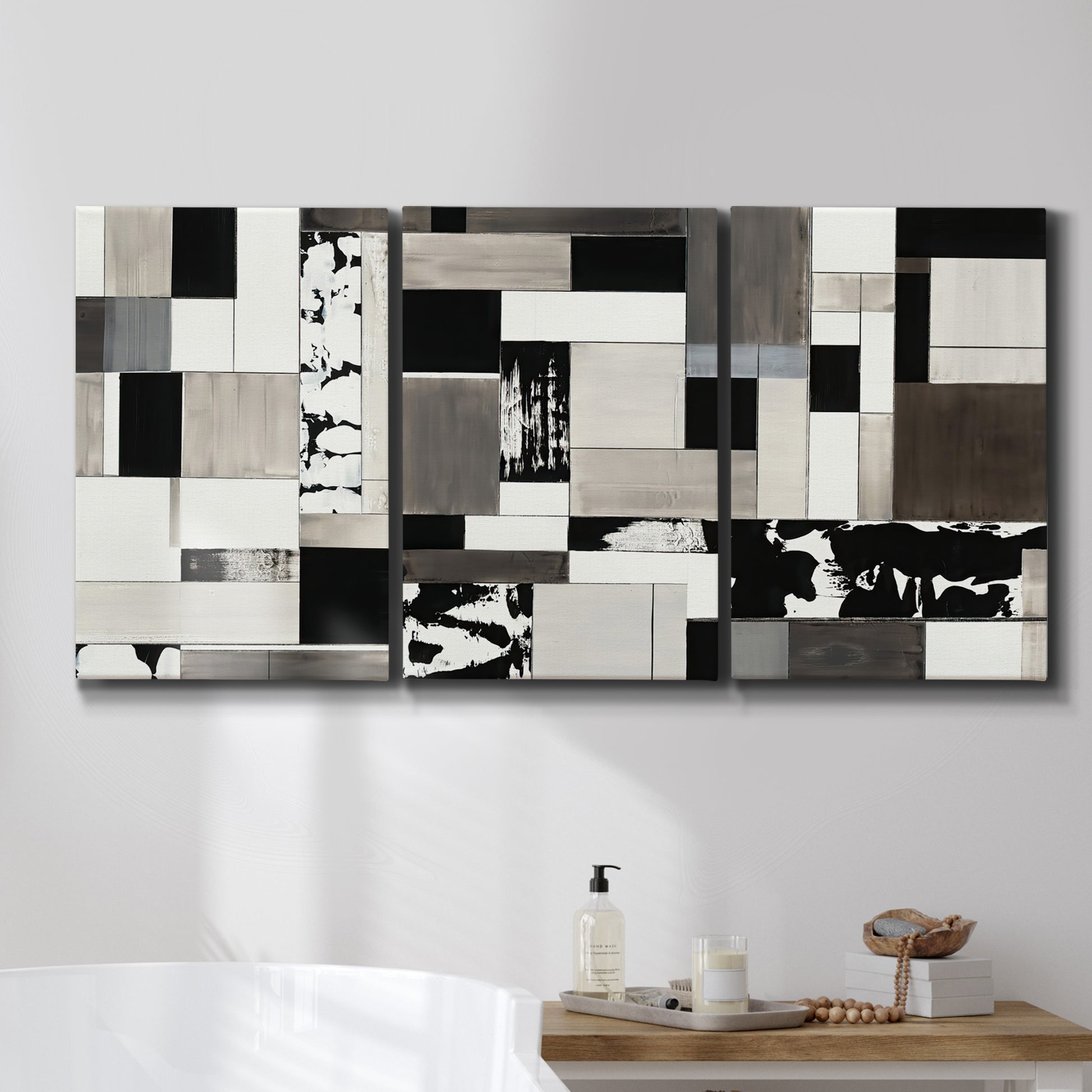 Three-panel canvas wall art featuring rectangular mid century geometric abstraction, displayed in a bathroom above a bathtub.