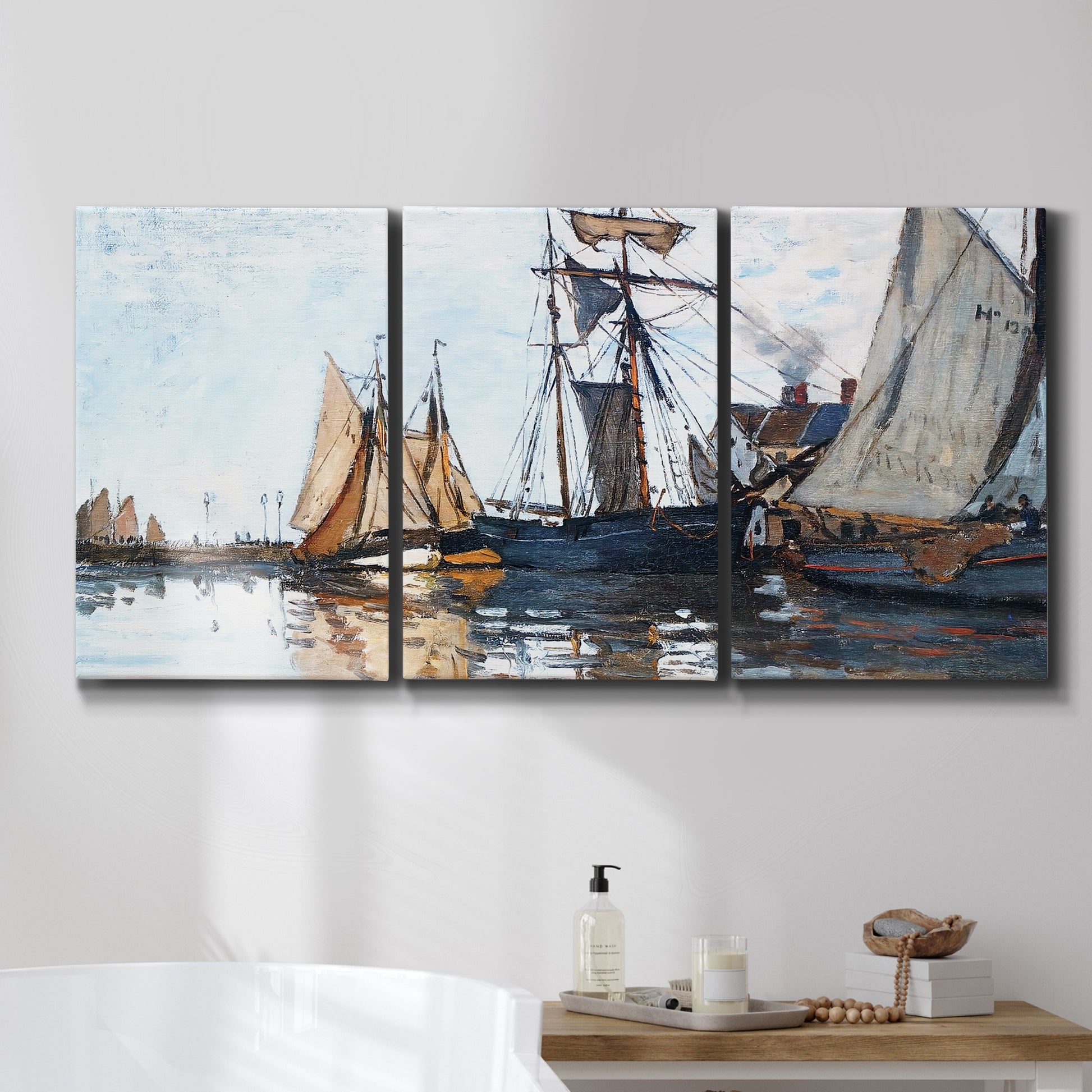 Three-panel canvas wall art featuring fishing boats navigating open water, displayed in a bathroom above a bathtub.