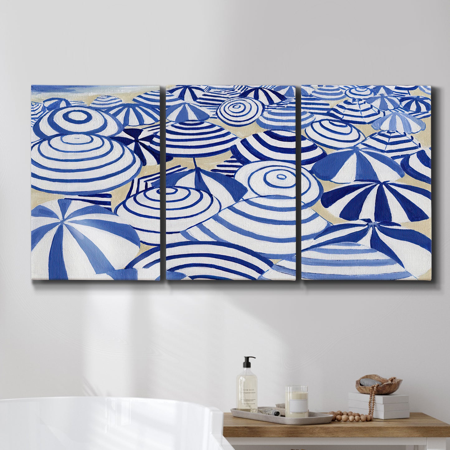 Three-panel canvas wall art featuring geometric abstract bowl forms, displayed in a bathroom above a bathtub.