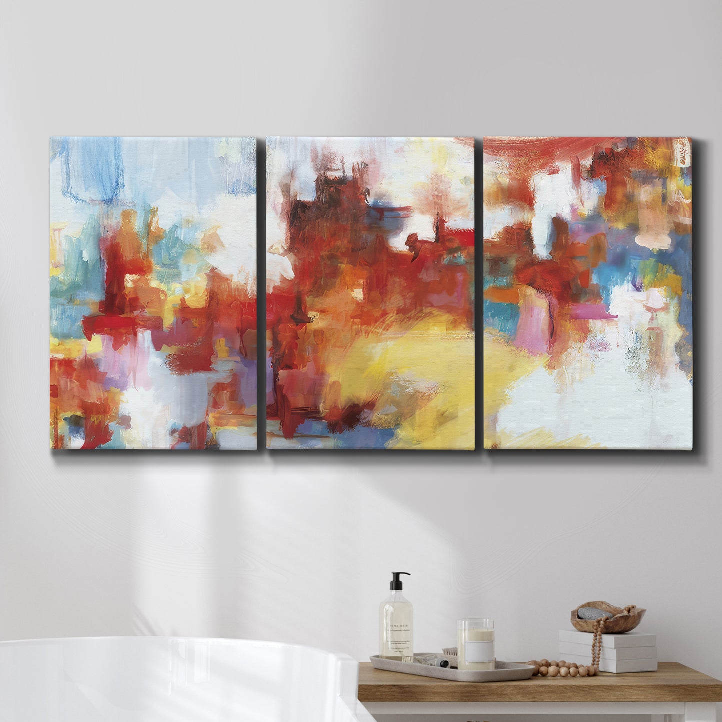 Three-panel canvas wall art featuring abstract city lights composition, displayed in a bathroom above a bathtub.