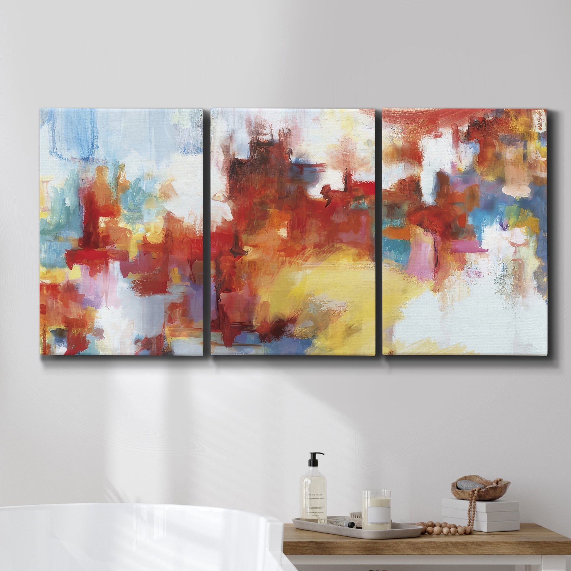 Three-panel canvas wall art featuring abstract city lights composition, displayed in a bathroom above a bathtub.