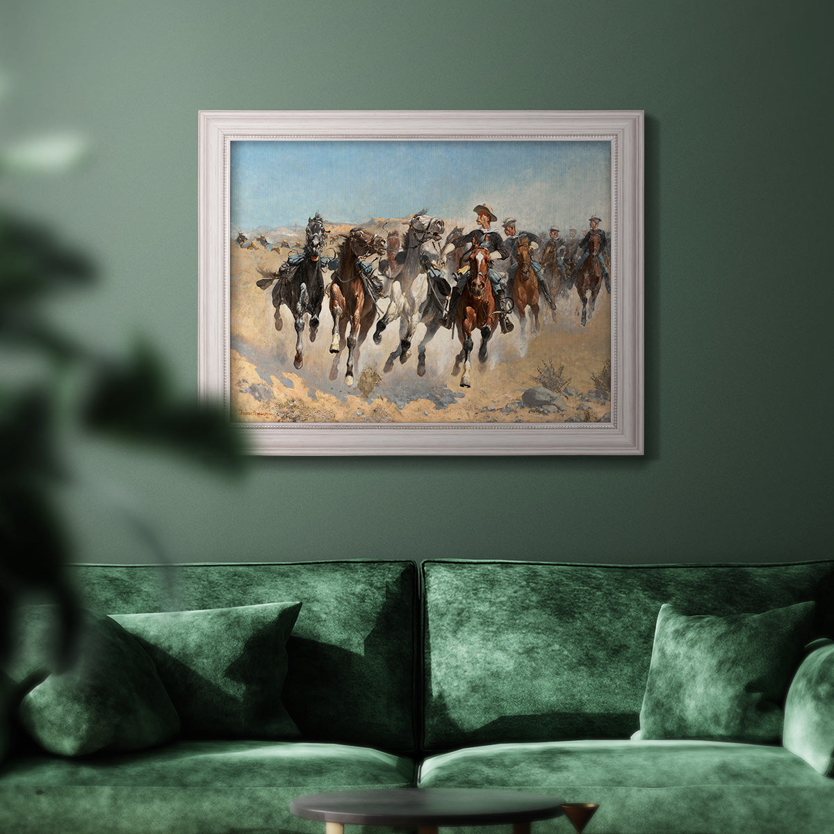 Impressionist western action scene by Frederic Remington in an ornate weathered white frame displayed in a dark-toned interior setting.