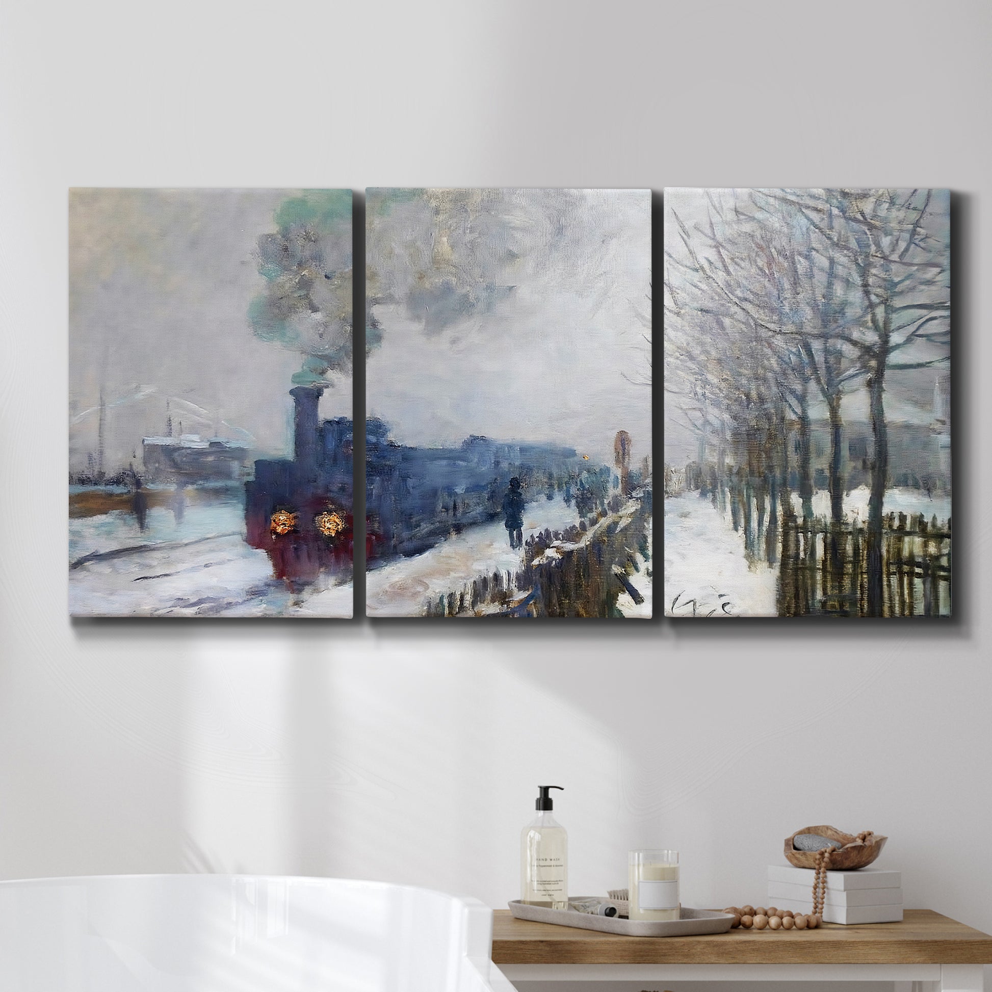 Three-panel canvas wall art featuring steam train in snowy landscape, displayed in a bathroom above a bathtub.