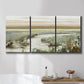 Three-panel canvas wall art featuring pastoral fields under soft sunrise, displayed in a bathroom above a bathtub.