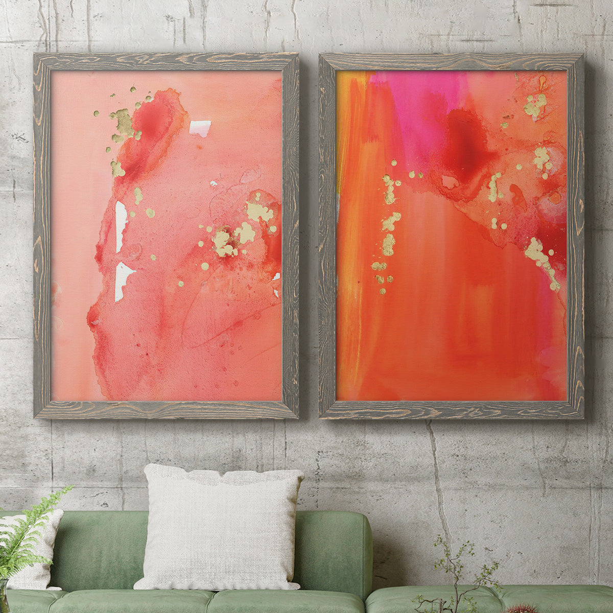 Set of two gray barnwood framed canvas prints depicting a coordinated art pair of luminous coral orange and pink color fields with gold flecks rendered as glamorous fluid abstracts above a sofa in a modern living room.